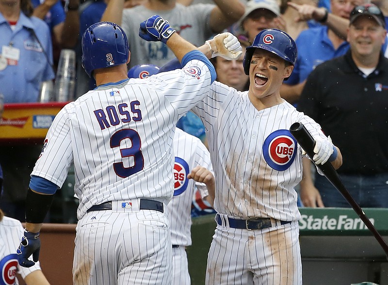 Chicago Cubs' Chris Coghlan, right, celebrates with David Ross (3) after Ross' home run during the sixth inning of a baseball game against the Seattle Mariners Friday, July 29, 2016, in Chicago. 