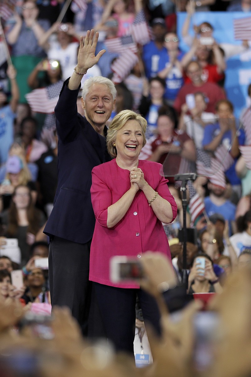 Democratic presidential candidate Hillary Clinton, with her husband, former President Bill Clinton, react as they arrive for a campaign rally at Temple University, Friday, July 29, 2016, in Philadelphia. 
