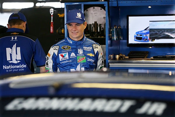 Jeff Gordon stands in the garage area Friday at Pocono Raceway during practice for Sunday's NASCAR Sprint Cup Series Pennsylvania 400 in Long Pond, Pa.