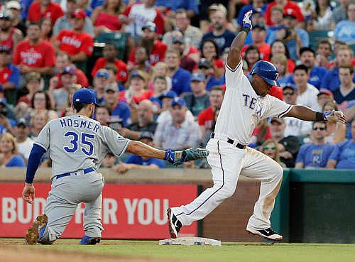 Adrian Beltre of the Rangers returns to first after thinking about trying to stretch a single into a double as Royals first baseman Eric Hosmer makes a tag during the fourth inning of Friday night's game in Arlington, Texas.