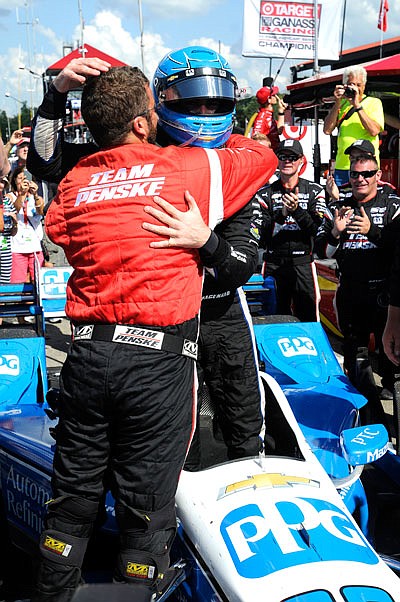 Simon Pagenaud is hugged by a crew member as he climbs from his car Sunday after winning the the Indy 200 at the Mid-Ohio Sports Car Course in Lexington, Ohio.