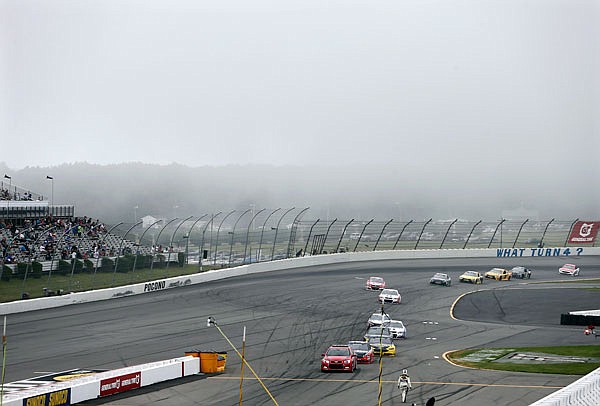 The pace car leads the field off the track as fog moves in Monday at Pocono Raceway during the Pennsylvania 400 in Long Pond, Pa.