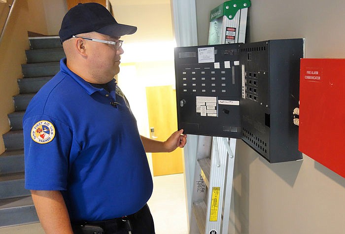 Ron Formantes, security officer at Westminster College, checks the school's fire panel, which keeps track of all the fire alarms.