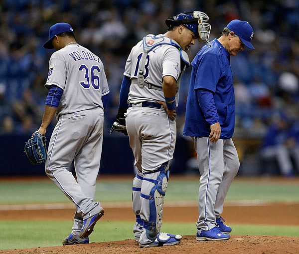 Royals manager Ned Yost (right) and catcher Salvador Perez (center) look down as starting pitcher Edinson Volquez leaves the game against the Rays during the sixth inning Wednesday night in St. Petersburg, Fla.