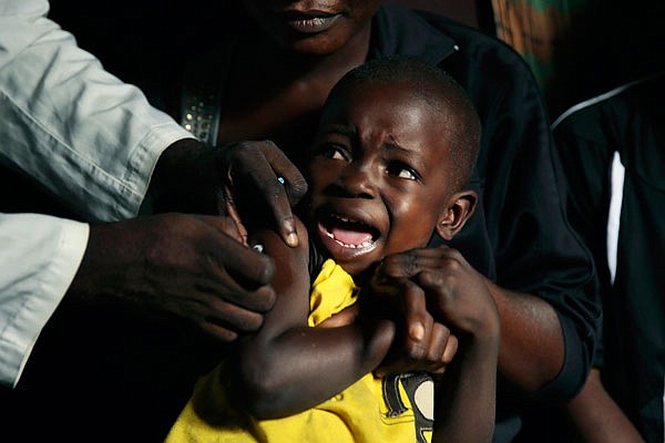 A boy reacts as he receives a yellow fever vaccine injection Thursday in the Kisenso district of Kinshasa, Congo. Yellow fever is not highly contagious and is easily prevented with vaccines. The disease is thought to have evolved in Africa about 3,000 years ago and was likely brought to the Americas by slave ships from West Africa.