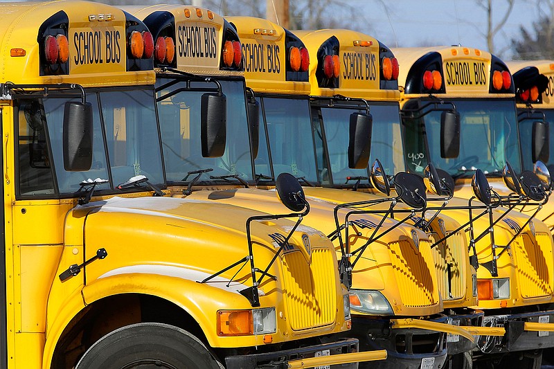 In this Jan. 7, 2015 file photo, public school buses are parked in Springfield, Ill. Once upon a time, finding out how your child was doing in school could require weeks of patience. You waited for the parent-teacher conference, for a return phone call from school if you were concerned and, eventually, for a report card to land in the mailbox. Now, a growing number of families can get instant access to grades and other school information through online parent portals.