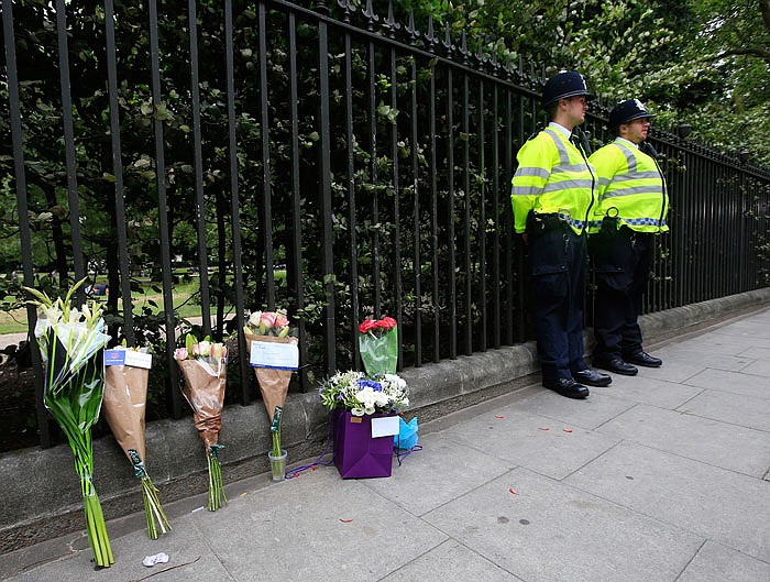 Floral tributes rest against railings Thursday near the scene of a fatal stabbing on Wednesday night in Russell Square, London. London police say they have found no signs of radicalization in a knife attack, which killed an American woman and injured five other people in London's Russell Square.  
