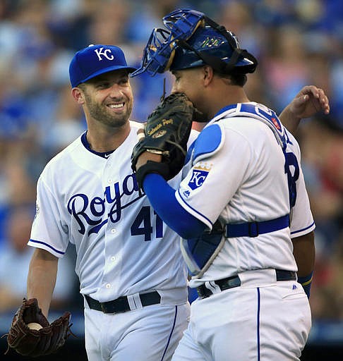 Kansas City Royals starting pitcher Danny Duffy (41) talks with catcher Salvador Perez, right, during the fourth inning of a baseball game against the Toronto Blue Jays at Kauffman Stadium in Kansas City, Mo., Saturday, Aug. 6, 2016.