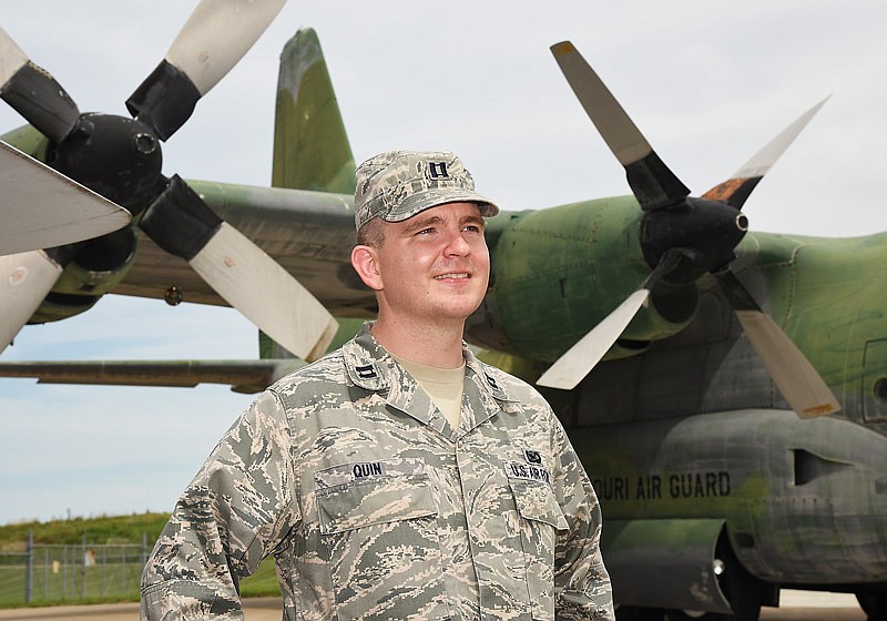 Capt. John Quin of the Missouri National Guard poses in front of the Museum of Missouri Military History's newest large acquisition, the C-130, at left, and the Phantom F4.