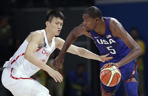 United States' Kevin Durant (5) drives past China's Zou Peng, left, during a basketball game at the 2016 Summer Olympics in Rio de Janeiro, Brazil, Saturday, Aug. 6, 2016. 