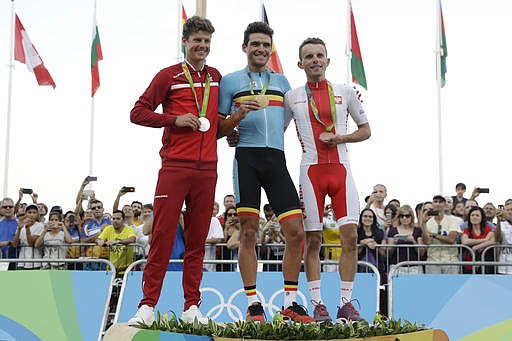 Gold medalist Greg Van Avermaet of Belgium, center, silver medalist Jakob Fuglsang of Denmark, left, and bronze medalist Rafal Majka of Poland , right, pose at the podium of the men's cycling road race final at the 2016 Summer Olympics in Rio de Janeiro, Brazil, Saturday, Aug. 6, 2016.