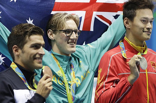 Winner Australia's Mack Horton, center, second placed Italy's Gabriele Detti, left, and third placed China's Sun Yang hold their medals after the men's 400-meter freestyle during the swimming competitions at the 2016 Summer Olympics, Saturday, Aug. 6, 2016, in Rio de Janeiro, Brazil.
