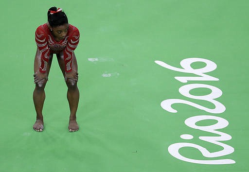 In this Aug. 4, 2016 file photo United States' Simone Biles waits her turn to train on the beam ahead of the 2016 Summer Olympics in Rio de Janeiro, Brazil. It shouldn't come as a surprise that some of the best-recognized names on the U.S. Olympic team belong to women. Biles is one of a record 292 women on the U.S. Olympic team. She could win up to five gold medals. 