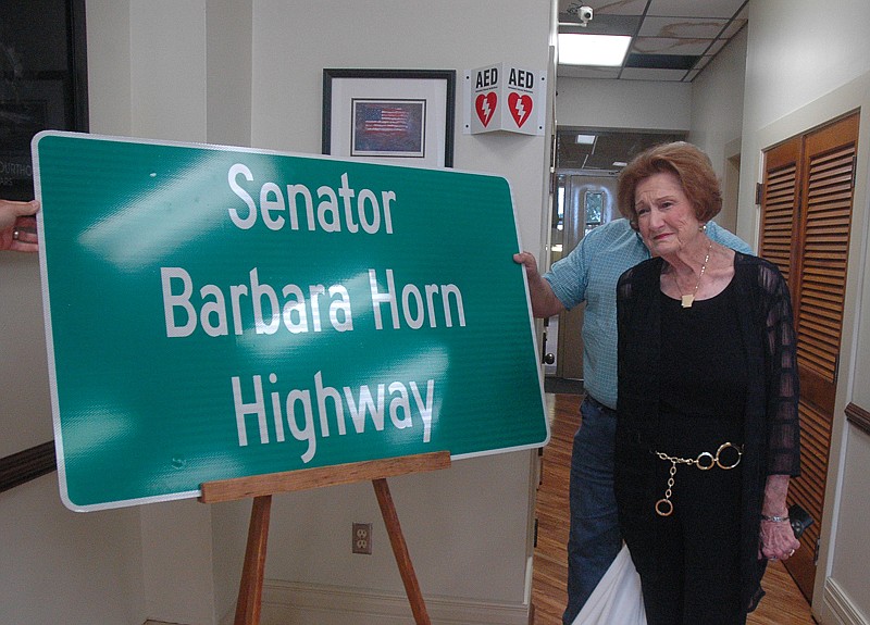 Barbara Horn, right, looks at a highway sign honoring her for representing Southwest Arkansas in both the state House of Representatives and the Arkansas Senate. Several of the highway signs will be installed on state Highway 41 near the intersection of Arkansas Highway 41 and Highway 32 north to the Foreman, Ark., city limits.