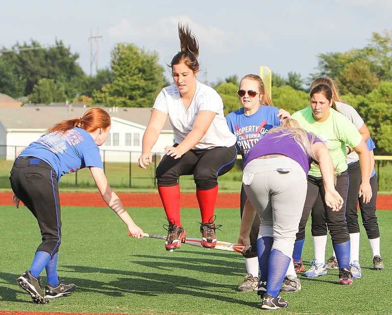 The Lady Pintos do the bat drill at Monday's practice.