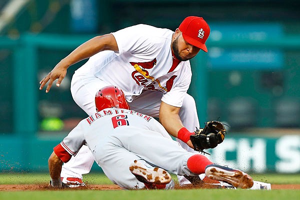 Reds center fielder Billy Hamilton is tagged out by Cardinals shortstop Jhonny Peralta after being picked off at second base during the first inning of Tuesday night's game at Busch Stadium in St. Louis. The Reds won 7-4 against the Cardinals.
