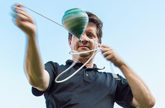 Chris Neff performs with a spin top. The local yo-yo/spin top expert recently won the spin top contest in 2016 World YoYo Contest in Cleveland.   