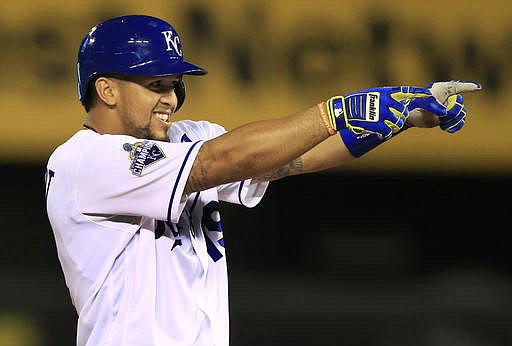 Kansas City Royals third baseman Cheslor Cuthbert gestures after hitting an RBI double in the eighth inning of a baseball game against the Chicago White Sox at Kauffman Stadium in Kansas City, Mo., Wednesday, Aug. 10, 2016.