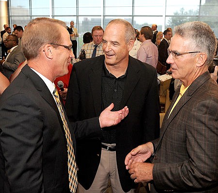 (From left) New University of Missouri athletic director Jim Sterk, former head football coach Gary Pinkel and former athletic director Mike Alden talk following a press conference Thursday at Faurot Field.