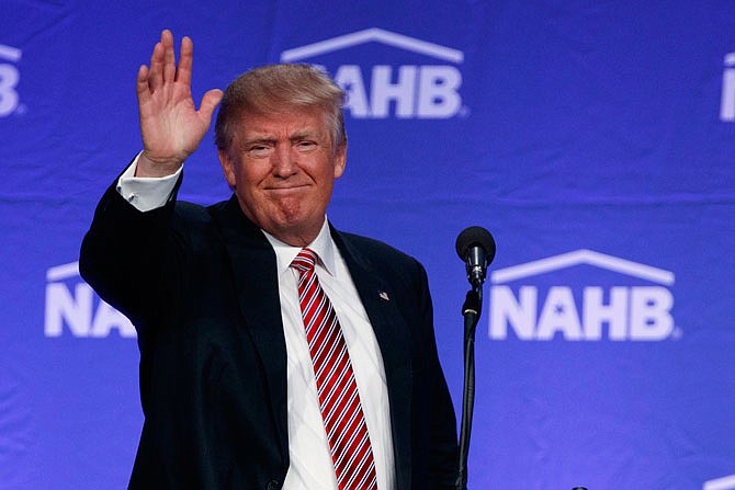 Republican presidential candidate Donald Trump waves after speaking to the National Association of Home Builders Thursday in Miami Beach, Florida.