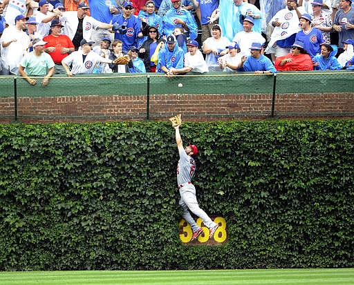 St. Louis Cardinals center fielder Randal Grichuk (15) can't catch a solo home run hit by Chicago Cubs' Jorge Soler during the sixth inning of a baseball game, Friday, Aug. 12, 2016, in Chicago.