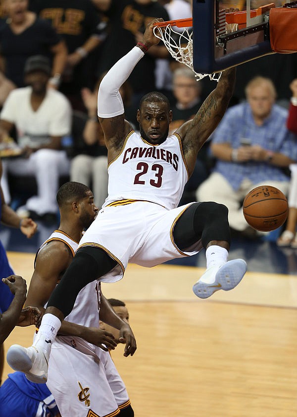 In this June 16 file photo, Cavaliers forward LeBron James dunks against the Warriors during the first half of Game 6 of the NBA Finals in Cleveland. James has signed his three-year, $100 million contract with the NBA champion Cavaliers. 
