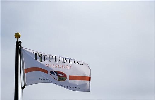 The city of Republic, Mo. flies it's newly redesigned flag outside city hall on Friday, Aug. 5, 2016. The city redesigned it flag as it's supply of flag was running low and to incorporate the city logo adopted in 2009 — a large "R," with a leafy green shoot weaving through it. (Nathan Papes/The Springfield News-Leader via AP)