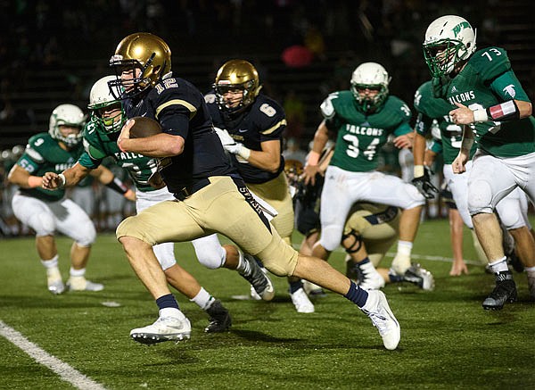 Helias quarterback Chandler Luebbert scoots around the Blair Oaks defense for a big gain during Friday night's jamboree at the Falcon Athletic Complex in Wardsville.