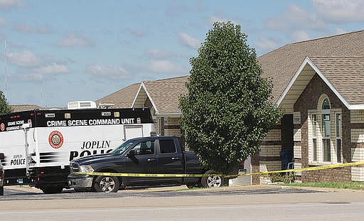 Joplin Police investigate the scene of a reported early morning shooting on Saturday, Aug. 13, 2016, near 20th and Connecticut streets in Joplin, Mo. Police received a call about a possible shooting at this residence around 5 a.m. Saturday. A suspect was arrested after an early morning shooting spree that injured five people and two service-dogs. (Laurie Sisk /The Joplin Globe via AP)