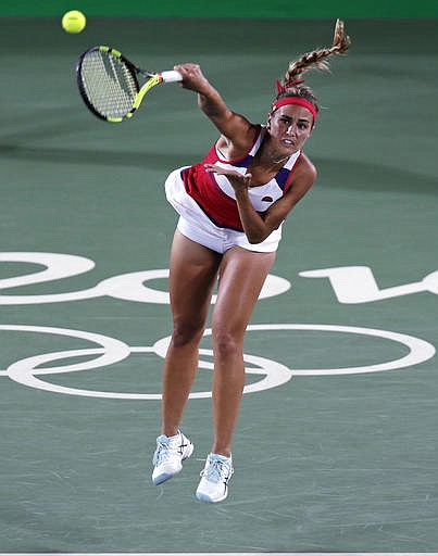 Monica Puig, of Puerto Rico, serves to Angelique Kerber, of Germany during their final round match at the 2016 Summer Olympics in Rio de Janeiro, Brazil, Saturday, Aug. 13, 2016.