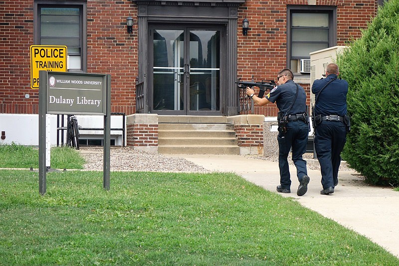 Police officers run into the building to contain the "shooter" during an active shooter drill Friday, Aug. 13, 2016 at William Woods University in Fulton.