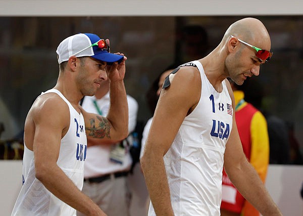 United States' Phil Dalhausser (right) and Nicholas Lucena (left) leave the pitch after losing to Brazil in Monday's men's beach volleyball quarterfinal match at the Summer Olympics in Rio de Janeiro.