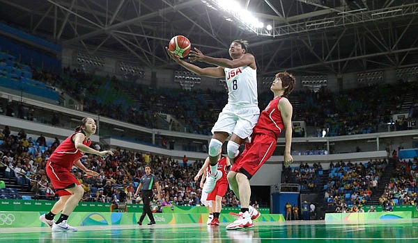 United States forward Angel McCoughtry (center) drives to the basket past Japan's Maki Takada (right) during Tuesday's women's basketball quarterfinal game at the Summer Olympics in Rio de Janeiro.