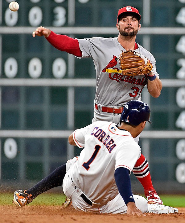 Cardinals shortstop Greg Garcia attempts a double play over Astros shortstop Carlos Correa during the seventh inning of Tuesday night's game in Houston. The Cardinals won their third straight game, beating the Astros 8-5 behind homers from Tommy Pham and Jedd Gyorko. 