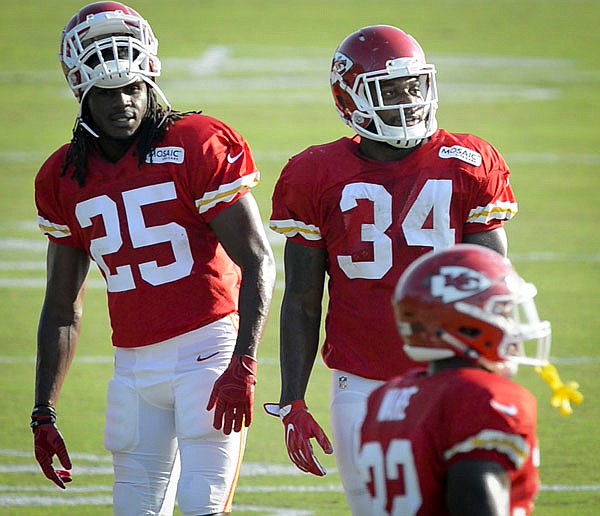 Chiefs running back Jamaal Charles (left) talks with running back Knile Davis as Charles made a limited return to practice Tuesday at training camp in St. Joseph.