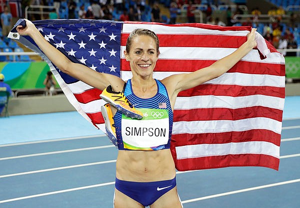 United States athlete Jenny Simpson displays the American flag after winning a bronze medal in the women's 1,500-meter final during Tuesday night's track and field competitions at the Olympic Stadium of the Summer Olympics in Rio de Janeiro.
