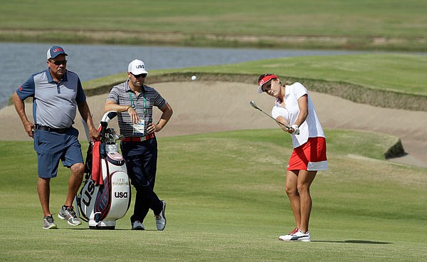 United States golfer Lexi Thompson chips to the green on the fifth hole during a practice round Tuesday at the Summer Olympics in Rio de Janeiro.