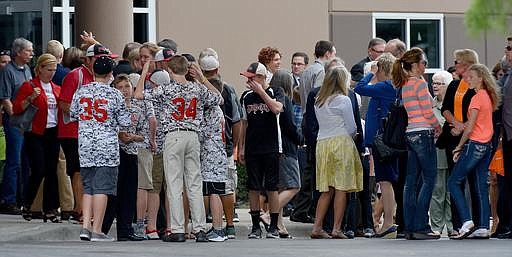 People leave the LifeMission Church following the funeral service for 10-year-old Caleb Schwab, Friday, Aug. 12, 2016, in Olathe, Kan. The son of a state legislator died Sunday, Aug. 7, while riding what's been billed as the world's tallest waterslide.