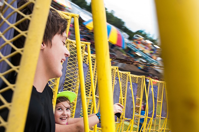 Chloe Hearon, right, looks over at Gabriel McCarty as they ride the Round Up Zero Gravity amusement ride Wednesday during the 46th annual New Boston Pioneer Days in New Boston, Texas. Pioneer Days continues daily this week through Saturday. 