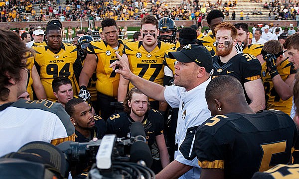 Missouri head coach Barry Odom addresses his players, including offensive linemen Kevin Pendleton (71) and Paul Adams (77), during Missouri's Black and Gold Game in April.
