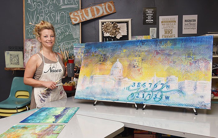 Michelle Livek shows a recent painting she made during a workshop at Shop Girl at 106 Boonville Road.
