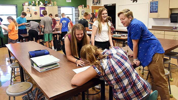 Aug. 18 meant the first day of school for students in the Blair Oaks School District, and these middle school students in Lori Jobe's art class started with a fun game designed to get to know each other better. Jobe, at right, helps eighth-grade students Sidni Libbert, lower left, Lauren Brendel and Hannah Verslues, white top, to answer as many questions as possible.