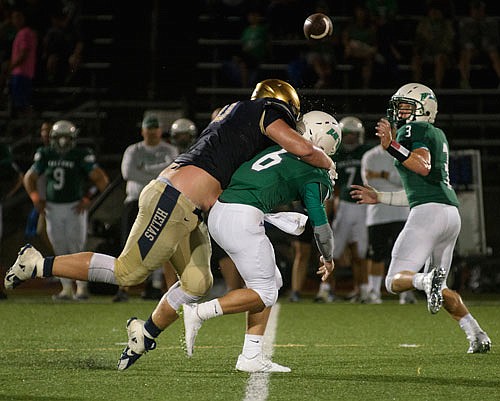 Helias defensive end Caleb Albertson gets to Blair Oaks quarterback Nolan Hair on a play during last Friday night's Jamboree in Wardsville.