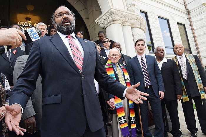 Jefferson City attorney Rod Chapel, Jr., left, stands in front of the 22 defendants in the Medicaid 22 trial Thursday, Aug. 18, 2016 to address media about the verdict reached in the Cole County trial. Standing to the right of Chapel is the Rev. John Bennett, of Jefferson City, and next to him is Jay Barnes, who served as co-counsel.
