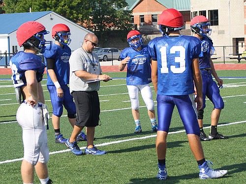 South Callaway head coach Zack Hess — who also serves as the Bulldogs' defensive coordinator — looks at his clipboard during Tuesday afternoon's practice in Mokane.