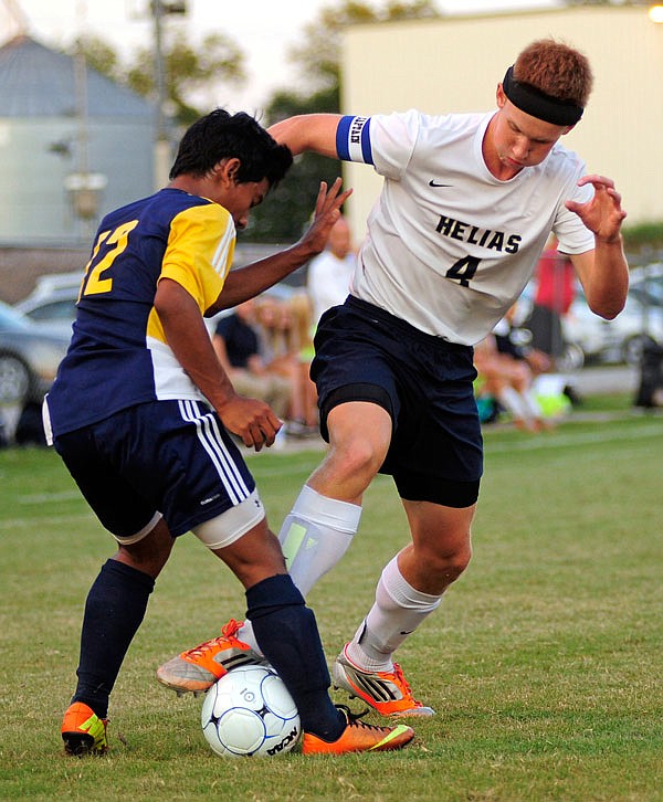 Helias midfielder Sam Heckart tries to control the ball while being challenged by Battle defender Ben Peng