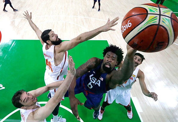 United States center DeAndre Jordan (right) shoots past Spain's Nikola Mirotic and Pau Gasol during a Friday's semifinal round game at the Summer Olympics in Rio de Janeiro.