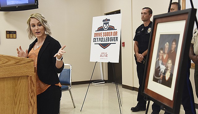 Johanna Henry, whose family was killed in a DWI crash in 2007, refers to the family's photo Friday as she talks about the incident that changed her and her family's life. She was at Troop F as the Missouri Highway Patrol announced the addition of a new item in their arsenal to aid in its attempt to remove impaired drivers from Missouri's roadways.