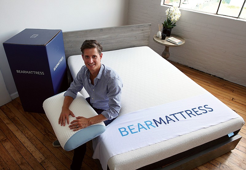 In this Tuesday, Aug. 16, 2016, photo, Scott Paladini, CEO of Bear Mattress, sits with a sample Bear Mattress, a newly-designed pillow and a shipping box in the company showroom in Hoboken, N.J. Bear Mattress has seen sales from mobile devices increase since it was launched in 2015. About half now come from phones and tablets and Paladini expects that to grow because 85 percent of company's online visitors are using mobile devices.