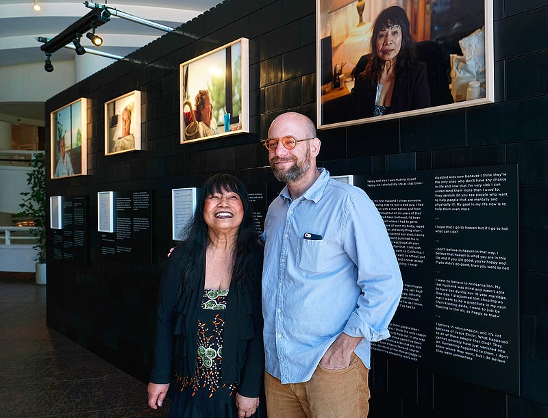 In this Aug. 15, 2016 photo, photographer Andrew George, right, poses with Nelly Gutierrez, who is featured in George's exhibit, "Right, Before I Die," at the Museum of Tolerance in Los Angeles. The exhibit, which features portraits of people facing serious illnesses, will run until Sept. 30. 